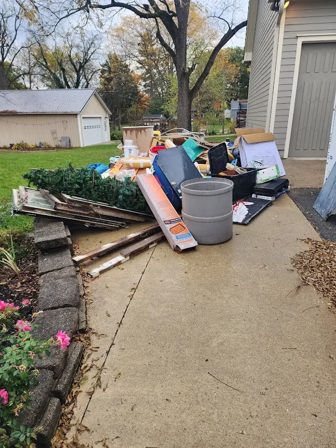 Dumpster being loaded with debris for 12 Yard Dumpster Rental in Yreka
